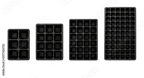 фотографія Four black plastic seed starter trays of varying sizes