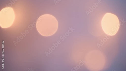 Abstract background with soft golden bokeh lights on a purple gradient backdrop.