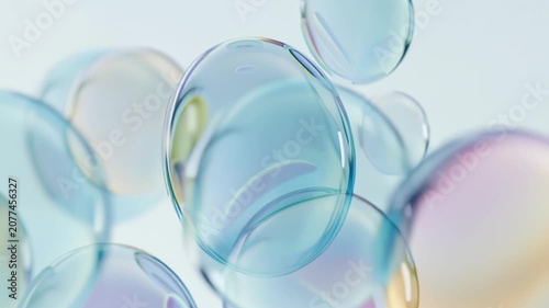 Colorful iridescent soap bubbles floating on soft pastel background