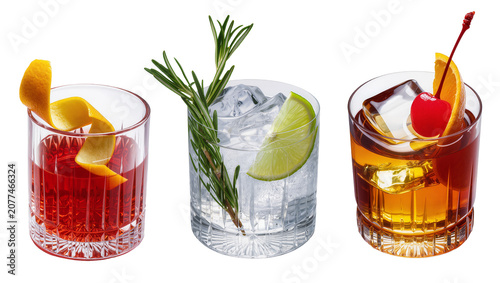 Photos Three cocktails with garnishes in crystal glasses