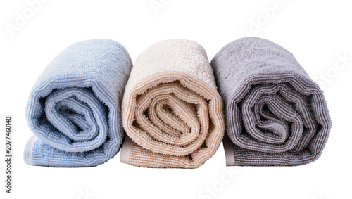 Fotografie Three rolled towels in pastel blue beige, and grey