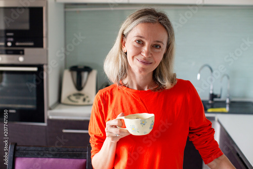 Konstfotografi Woman drinking coffee in modern kitchen