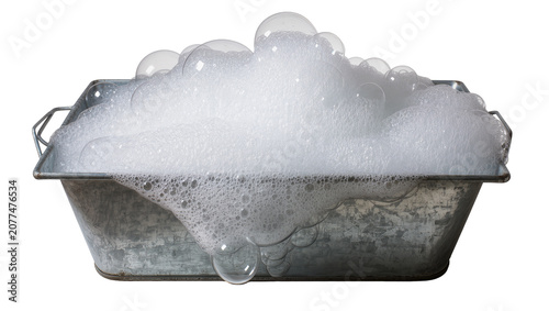 Galvanized metal tub overflowing with white soap bubbles