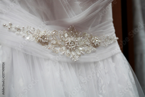 Canvas Print an element of a wedding dress decorated with decorative stones, beads, and sequi