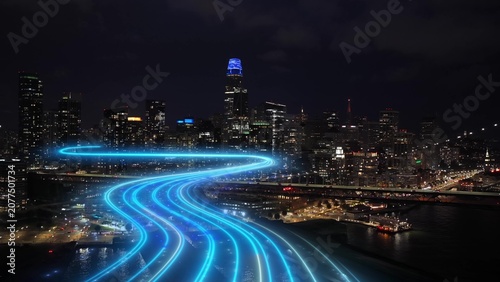 San Francisco smart city skyline glows at night as 5G and 6G digital network trails flows through the futuristic downtown