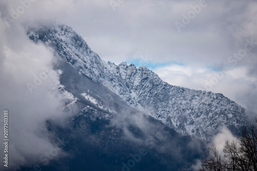 Snowy mountain top with clouds