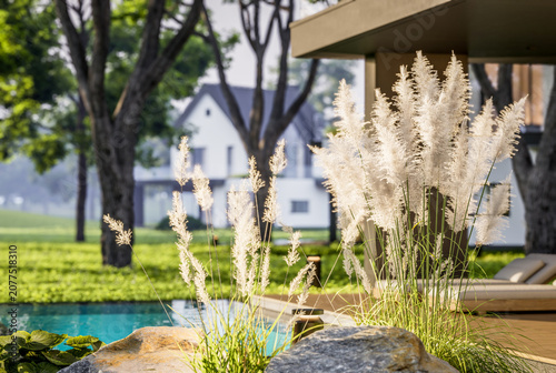 3d rendering of contemporary architectural luxury house exterior. Modern Scandinavian style family home with a white plaster walls, dark roof, and beautiful garden at golden hour