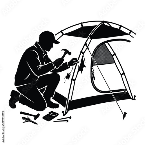 Foto Hiker setting up a tent with a hammer and other tools on a camping trip