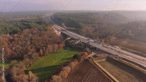 Beautiful autumn forest with a new highway in Poland.