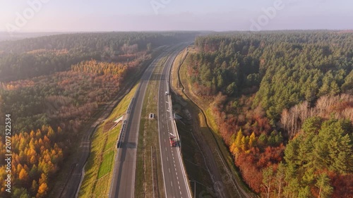 Beautiful autumn forest with a new highway in Poland.