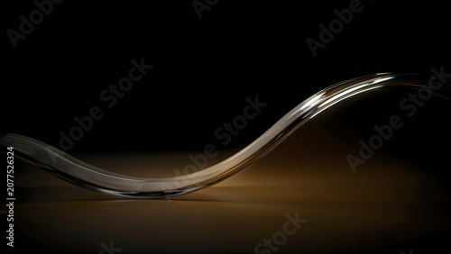 Sshaped glass or crystal object on brown surface  isolated on dark background