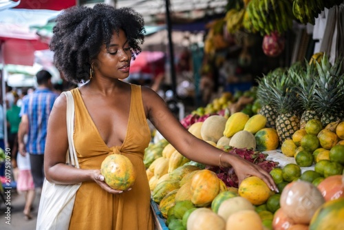 Woman choosing fruit at market stall