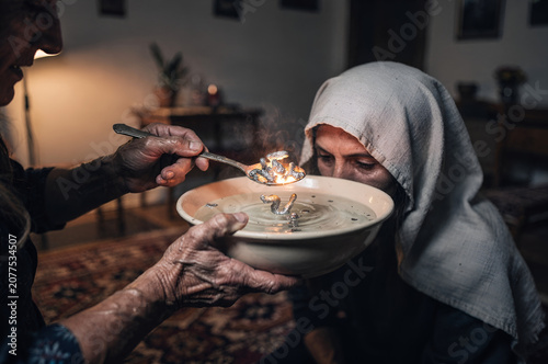 A close-up of a mystical traditional Turkish ritual known as pouring lead into water to ward off the evil eye with smoke and fire