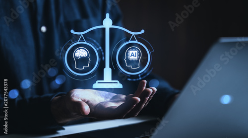 Digital depiction of balanced scales comparing human intelligence and artificial intelligence symbols hovering over a human hand in a glowing technological environment.