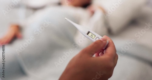 Close-up of a digital thermometer displaying elevated body temperature while a sick patient rests in bed. Concept of fever, illness, infection, healthcare, home care, and medical diagnosis.