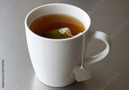 White mug with tea bag and hot tea