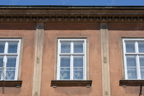 Принти на полотні A horizontal medium shot of a brown historic building facade with white wooden w