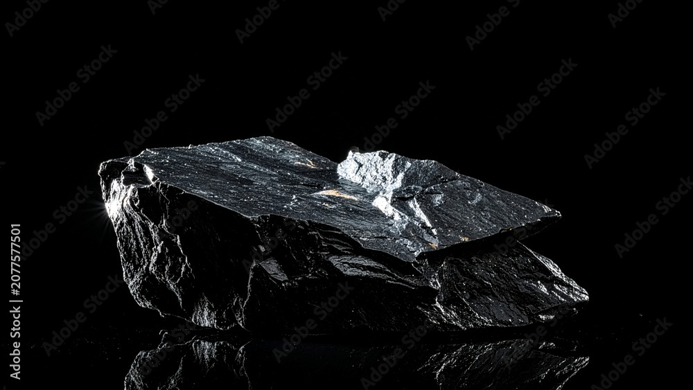Naklejka premium Wet Jagged Dark Rock with Shiny Surface and Reflection on Black Background