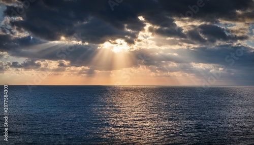 Sunlight Rays Breaking Through Dramatic Clouds Over A Vast Ocean Horizon Peaceful Seascape With Cinematic Sky And Calm Atmospheric Depth Realistic Detail No Logos