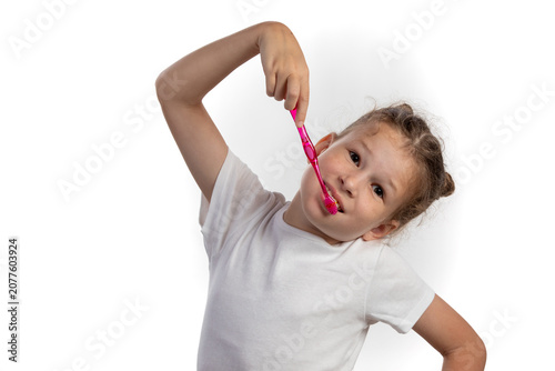 Young Girl Brushing Teeth with Pink Toothbrush Isolated on White Background