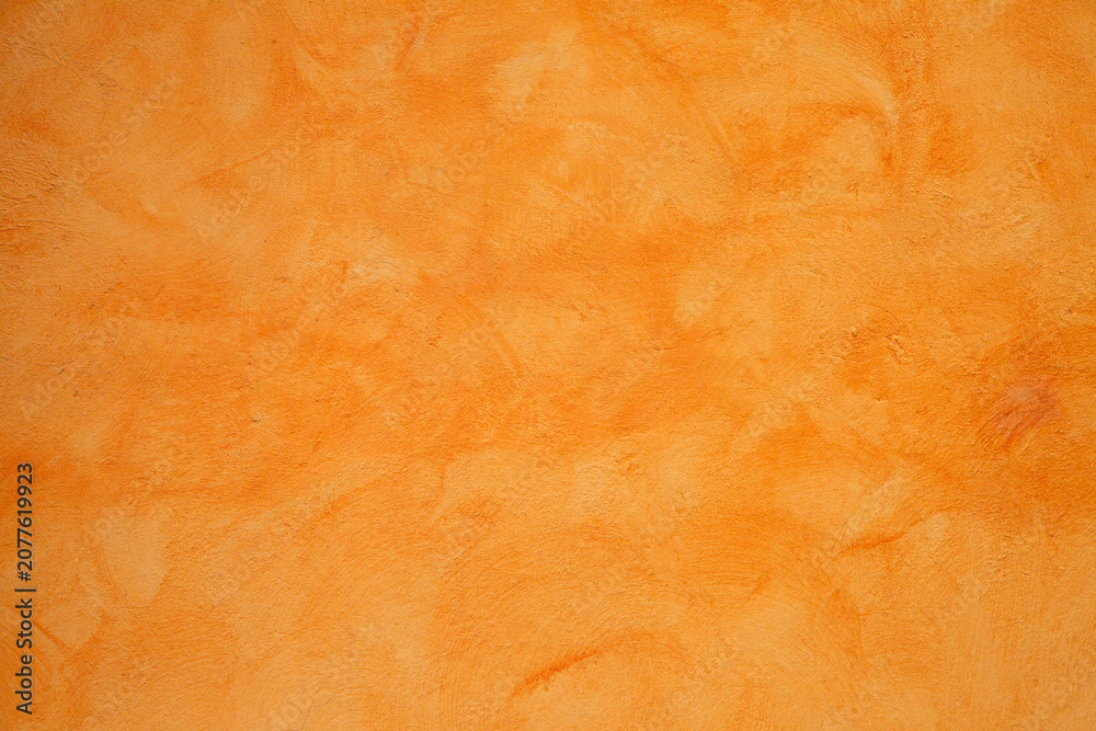 Fototapeta premium Soft burnt orange surface featuring gentle shading and grain