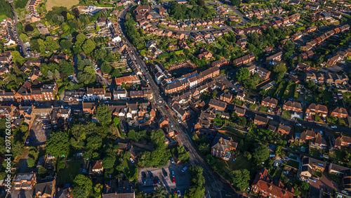 Top down drone view of english town center with red brick houses and main high street