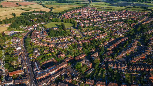 High angle view of british village with brick houses and green cricket field