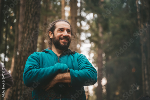 portrait of a man in a forest smiling