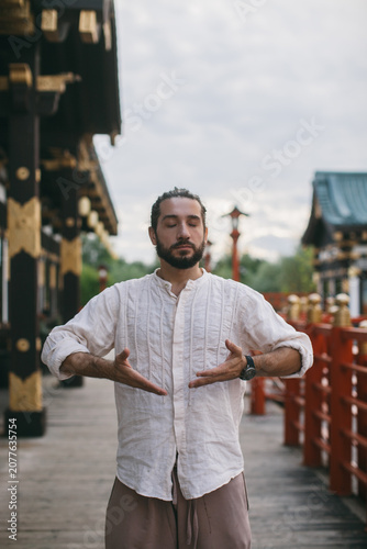 portrait of a man meditating standing on the street japan chinese background