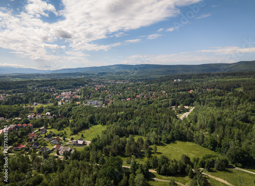 Aerial photograph of Polanica-Zdrój with the Sudety Mountains in the background, late spring mountain landscape.