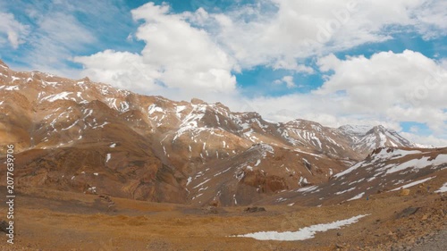 4K shot of clouds above the Himalayan mountain range with snow above them as seen near Lachulung La on Leh Manali highway between Sarchu and Pang in Ladakh, India. Natural background with copy space.