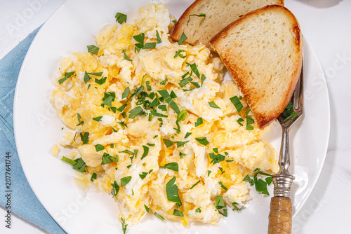 Traditional breakfast scrambled eggs with toasted bread