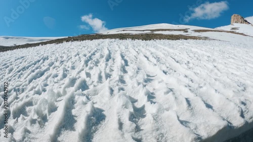 4K shot of Penitentes or or nieves penitentes formed at the high altitude mountain pass at Tanglang La on Leh Manali highway during the summer season. Scenic view of snow in high altitudes of Himalaya