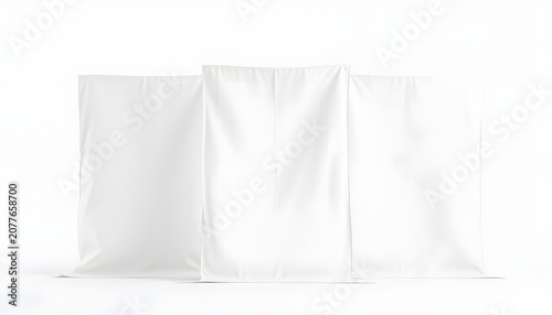 Three large blank white empty plain fabric bolts standing against white isolated background, grunge. White tone