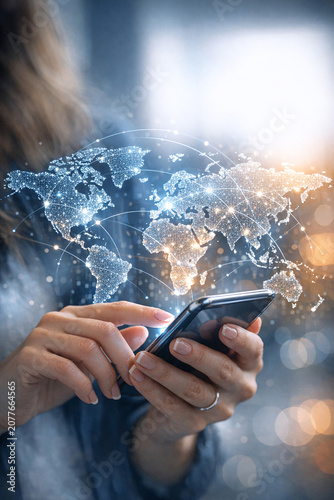 Person using mobile phone in modern office environment