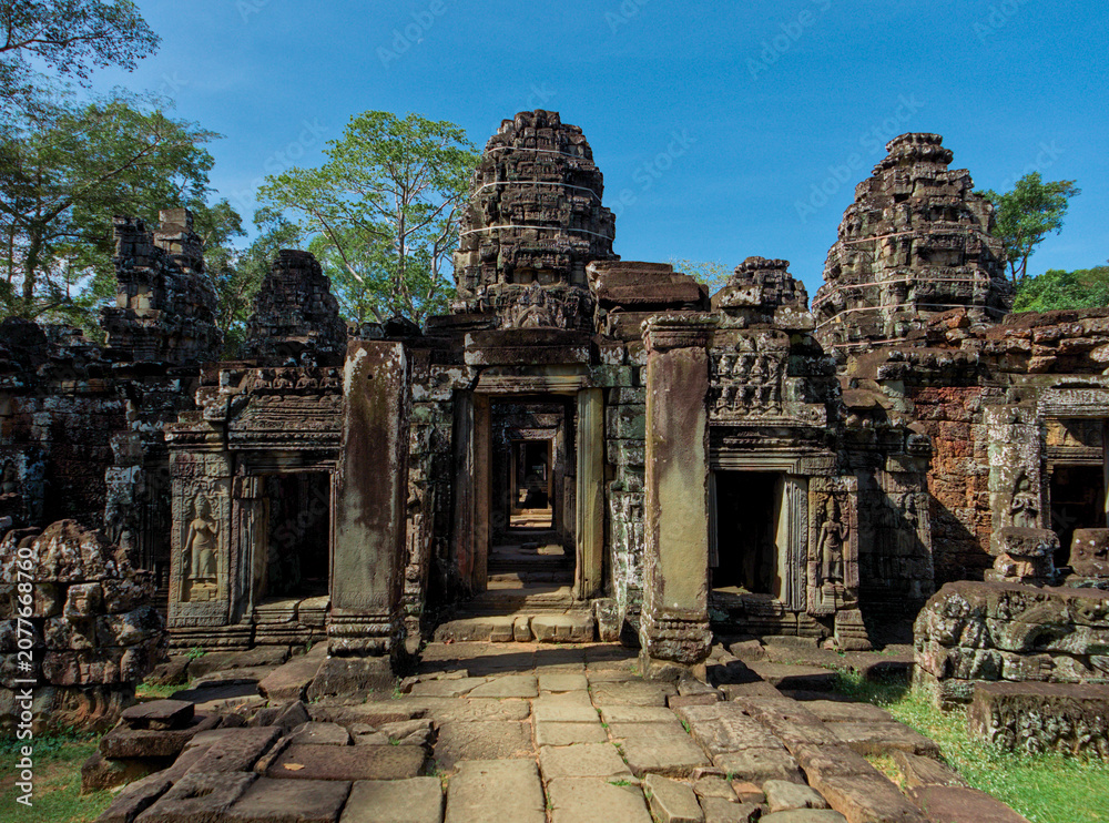 Fototapeta premium Ancient Stone Corridor with Aligned Doorways at Banteay Kdei Temple, Angkor, Cambodia