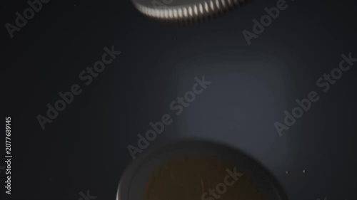 Spinning bimetallic coin entering upper-right, drifting over navy glow, revealing embossed face