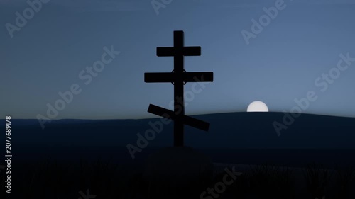 Rising sun slowly lighting hills, solitary multi-bar cross silhouette standing centered on rise