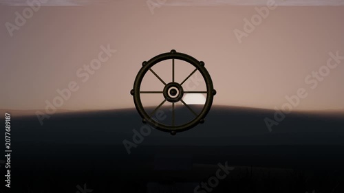 Brightening backlight near horizon revealing ship's wheel at sea dawn, with dark water