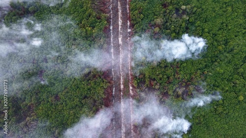 Aerial view shows deforestation and smoke rising
