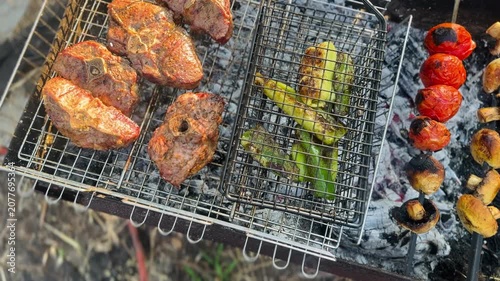 Grilling Marinated Lamb and Fresh Vegetables on Outdoor Barbecue