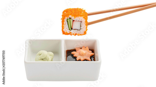 Slika na platnu California roll sushi with tobiko roe cucumber crab stick, and avocado held by c