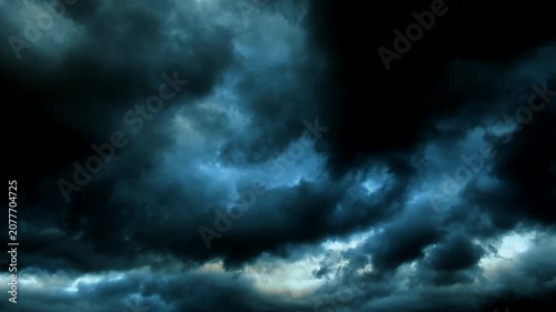 Low heavy clouds moving across the sky at sunset. 
The evening light illuminates only the tops of the dense clouds,