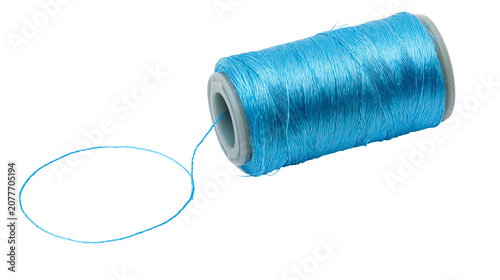 Fotografie Blue thread spool with loose strand