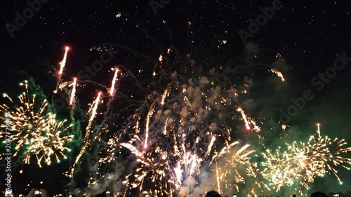Vibrant fireworks display at night celebration: pyrotechnics show with glowing sparks and smoke for new year’s eve and holiday events