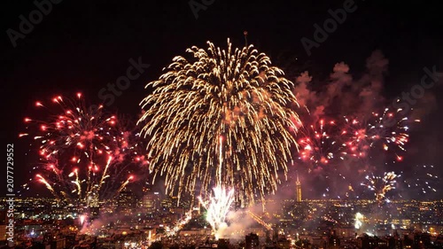 Fireworks display over city skyline at night: vibrant pyrotechnics celebration for new year’s eve, independence day, and festive events