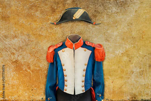 Vintage Napoleon costume with hat on a weathered background