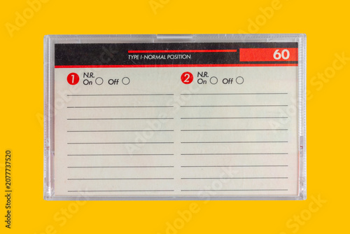 Vintage box for a compact cassette with copy space on a yellow background