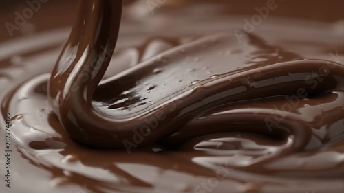 Rich Glossy Melted Chocolate Swirling Smoothly in Close-Up