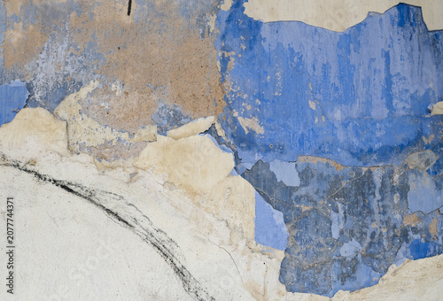 Weathered blue peeling paint texture on heritage shophouse wall in George Town Penang